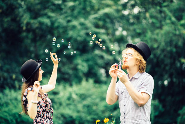 istock Couple blowing bubbles outdoor 2194443663