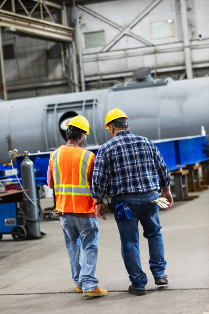 istock Two multiracial workers in steel fabrication factory 2194444436