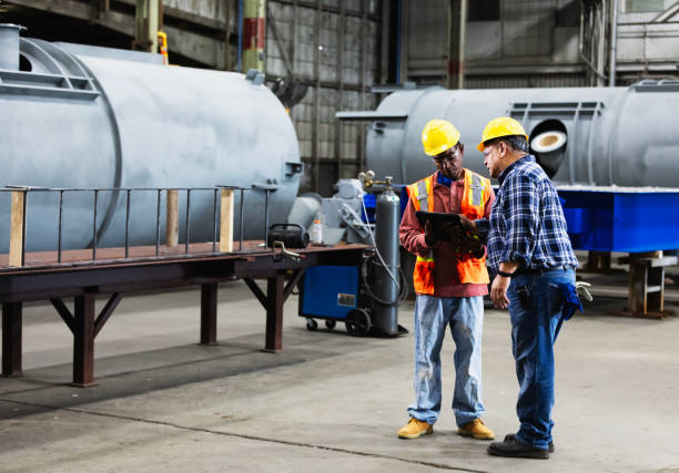 istock Two multiracial workers in factory with digital tablet 2194444442