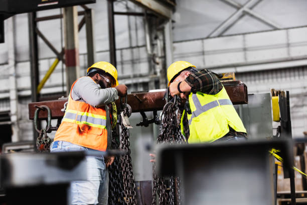 istock Men in warehouse with  chain slings for overhead crane 2194444514