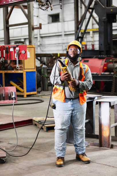 istock Black man in warehouse with control for overhead crane 2194444521