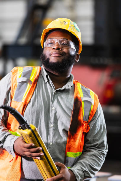 istock Black man in warehouse with control for overhead crane 2194444533