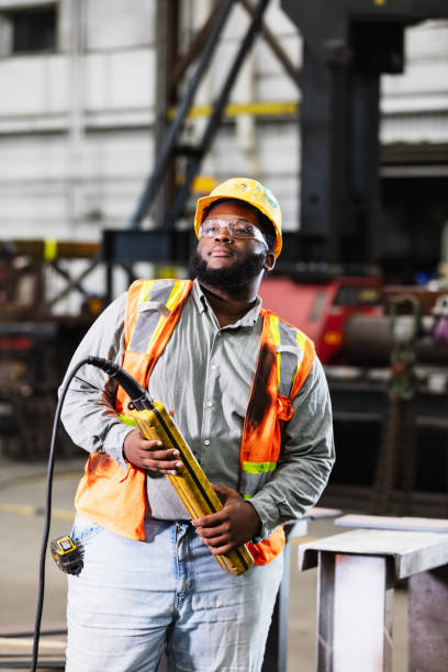 istock Black man in warehouse with control for overhead crane 2194444535