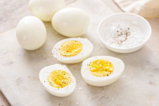 istock Boiled eggs peeled and cut in half with salt and pepper 2194445618