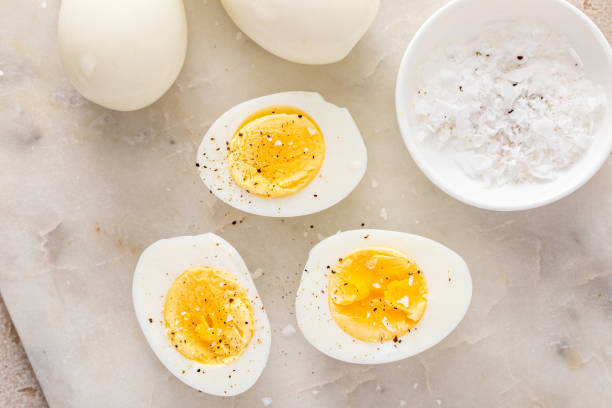 istock Boiled eggs peeled and cut in half with salt and pepper 2194445622