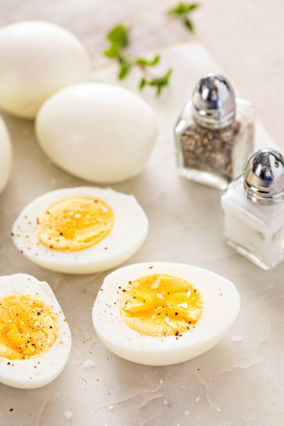 istock Boiled eggs peeled and cut in half with salt and pepper 2194445623