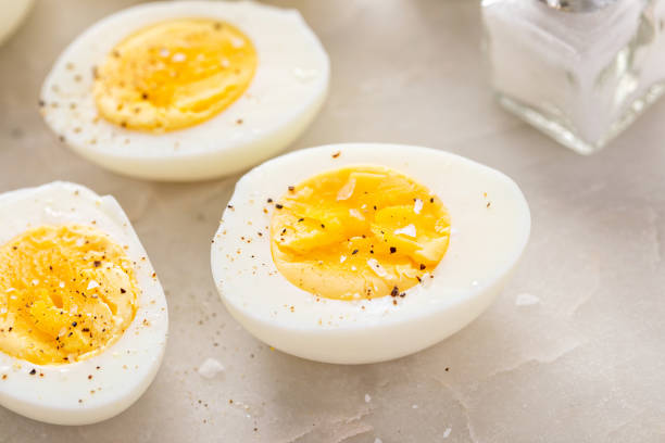 istock Boiled eggs peeled and cut in half with salt and pepper 2194445626