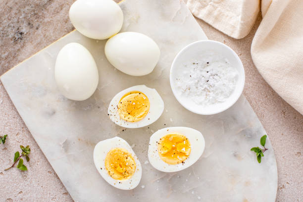 istock Boiled eggs peeled and cut in half with salt and pepper 2194445629