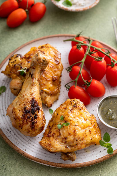 Roasted chicken drumsticks and thighs with pesto and tomatoes