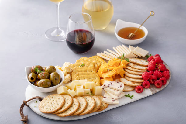 istock Cheese and snacks board with olives and crackers 2194445728