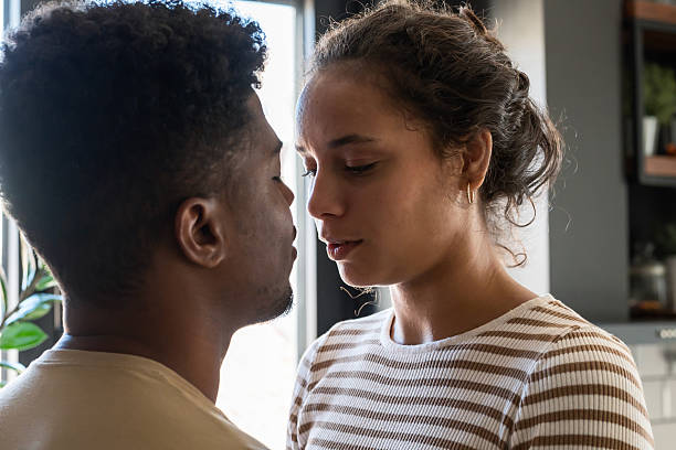 istock A close and intimate moment as a couple gently touches foreheads, sharing a quiet connection in soft natural light 2194446212
