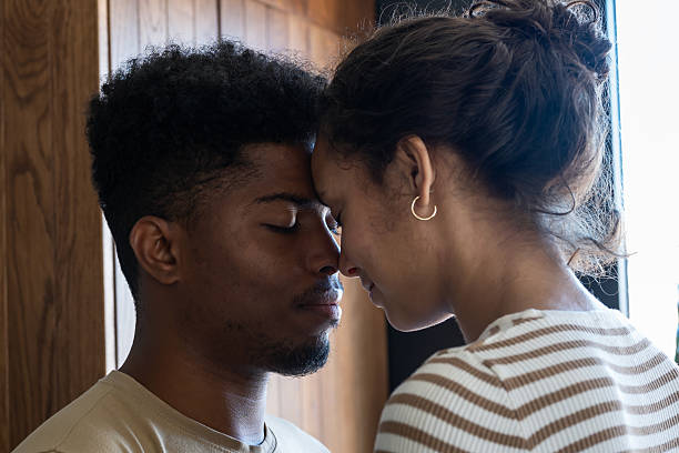 istock A close and intimate moment as a couple gently touches foreheads, sharing a quiet connection in soft natural light 2194446241