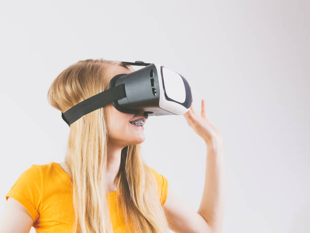istock Girl wearing virtual reality goggles. 2194446463