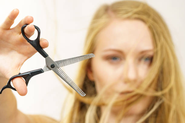 istock Girl with scissors thinning shears 2194447299