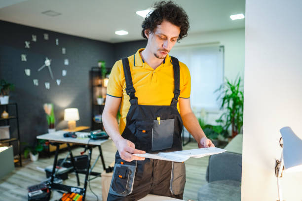 istock Handyman reading instructions for house repair project 2194447639