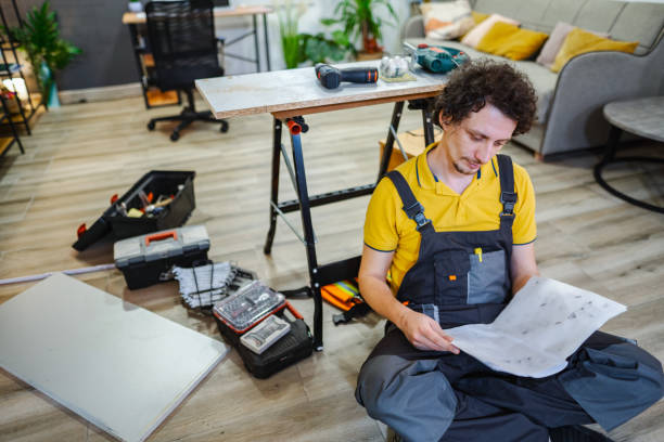 istock Handyman reading instructions for assembling furniture at home 2194447710