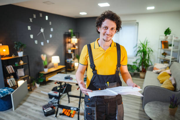 istock Handyman holding instructions showing his work in a modern apartment 2194447720
