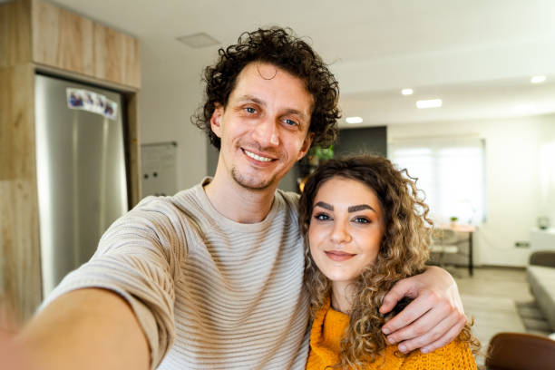 istock Happy couple taking a selfie in their modern apartment 2194447989