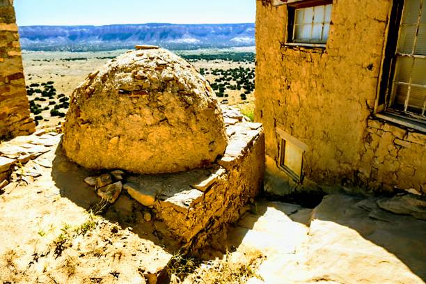 Española, NM: Houses under a rocky cliff near the town of Espanola in northern New Mexico, about 25 miles north of Santa Fe.