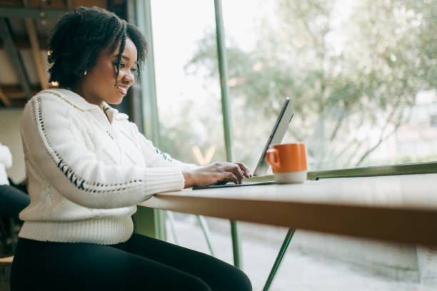 istock Woman Working on Tablet Computer At Coffee Shop 2194458105