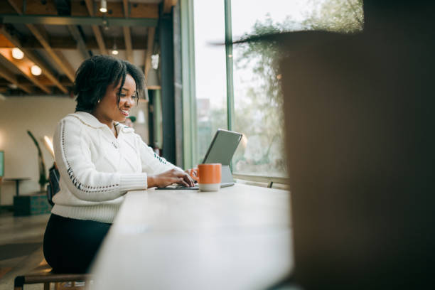 istock Woman Working on Tablet Computer At Coffee Shop 2194458107