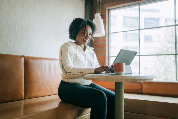 istock Woman Working on Tablet Computer At Coffee Shop 2194458217