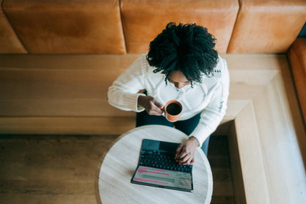 istock Woman Working on Tablet Computer At Coffee Shop 2194458326