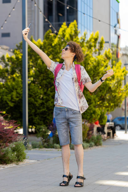 istock Tourist with backpack trying to catch a communication signal and Internet connection on mobile phone 2194461819