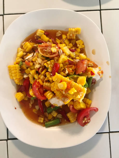 istock Thai spicy corn salad in white dish on the table, Thailand. 2194465642