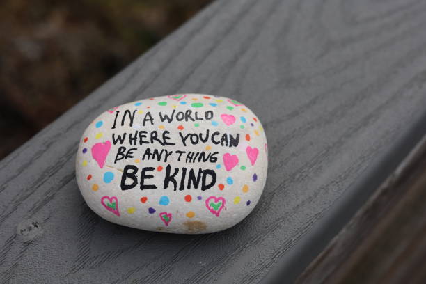 istock Be kind kindness rock on fence rail 2194475045