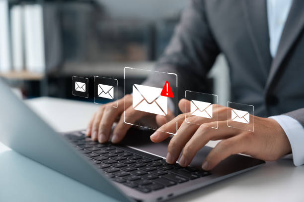 Email security, spam virus alert in email, businessman using smartphone to access email protected.