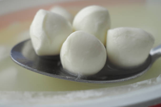 istock Many fresh white mozzarella cheese balls on spoon 2194476774