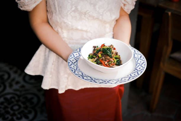 istock Thai-style stir-fried hot basil dish served in a traditional patterned bowl, Featuring fresh vegetables, Aromatic herbs and bold spices, Capturing the authentic flavors of Thai cuisine 2194478694