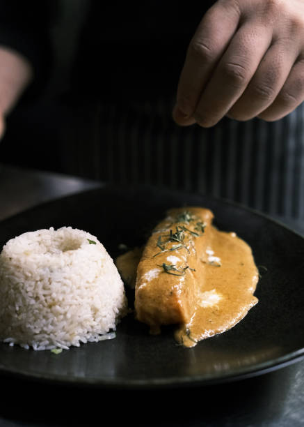 istock Thai Restaurant Style Chu Chee Salmon Curry Served with Steamed Jasmine Rice, Featuring Authentic Flavors and Aromatic Herbs in a Gourmet Presentation 2194478875