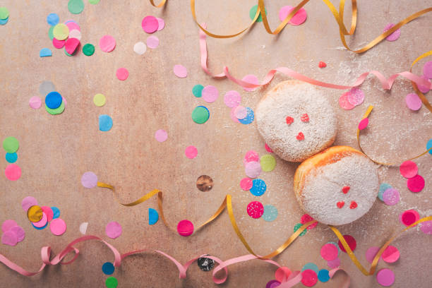 Colorful carnival or party background with donuts, streamers and confetti