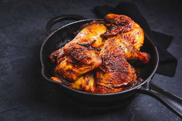 istock Delicious grilled chicken in iron pan on black background 2194483755