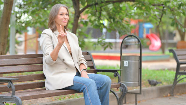 istock Old Woman in Denial while Sitting on Bench Outdoor 2194484977