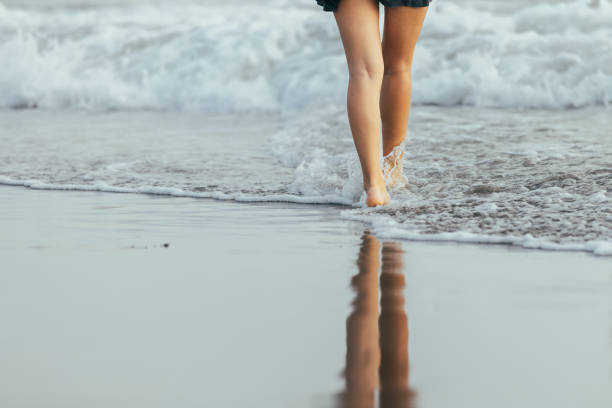 istock Barefoot woman is walking on Canggu beach. 2194485738