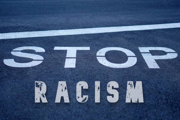 istock stop racism. Activism for equality. letters written on the road. 2194486714