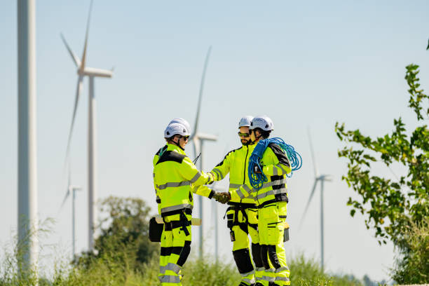 istock Professionals collaborate at a wind farm site during bright daylight to enhance energy production and safety measures 2194486835
