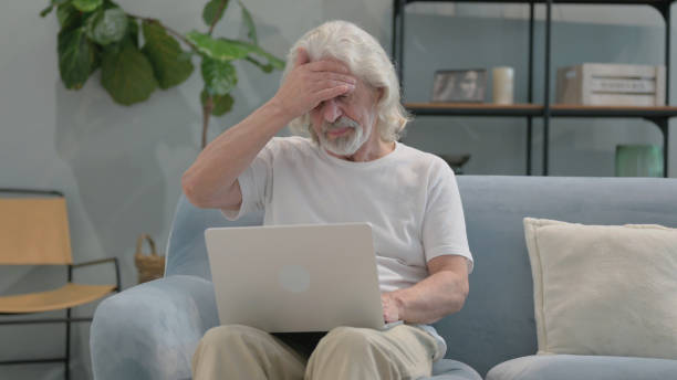 istock Old Man having Headache with Laptop in Lap 2194487246