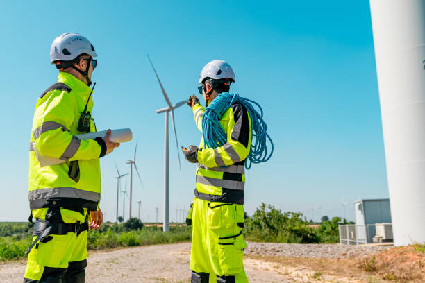 istock Two technicians discuss wind turbine maintenance at a renewable energy site during a clear sunny day 2194487543