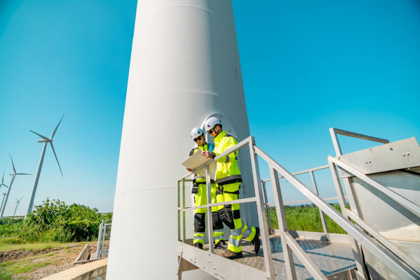 istock Wind turbine technicians inspecting equipment at a renewable energy facility during the day 2194487570