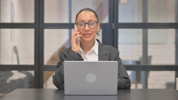 istock Mixed Race Business Woman Talking on phone at Work 2194488977