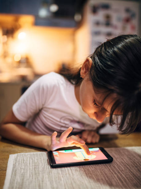 istock Young Girl Using Smartphone at Home in Evening Interior Setting 2194491177
