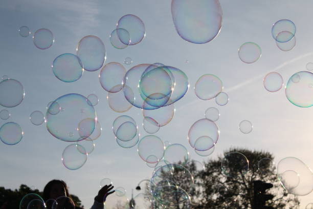 istock Children Reaching to Pop Bubbles Outside 2194492441