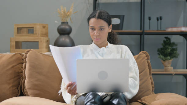 istock African Woman Doing Paperwork with Laptop 2194492839