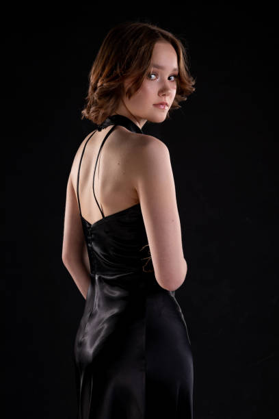 istock An Elegant Model Wearing a Stunning Black Dress Posed Against a Dark, Dramatic Background 2194493983
