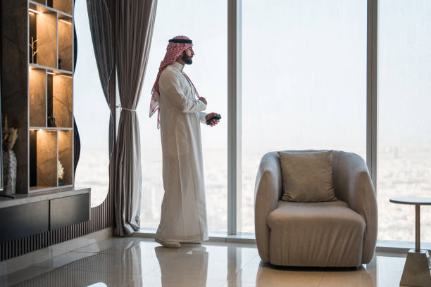 istock Focused Arabic Businessman Admiring Riyadh Skyline from Modern Home 2194497482