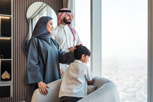 istock Joyful Arabic Family Admiring Riyadh Skyline from Modern Home 2194497499